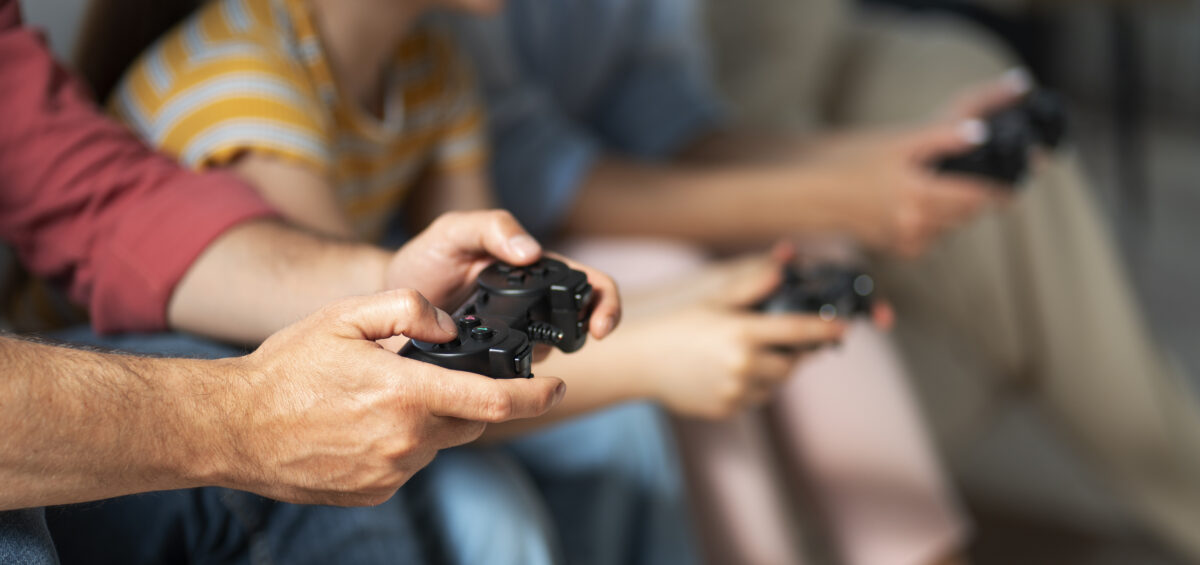 side view family playing videogame